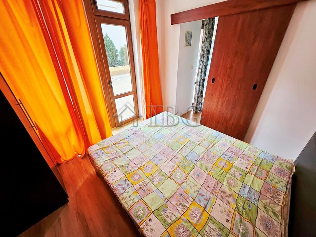 Bright 1-bedroom apartment with pool view, large windows, and colorful curtains in Sveti Vlas.
