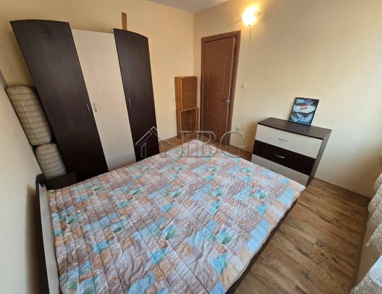 Bright bedroom with a double bed and wardrobe.