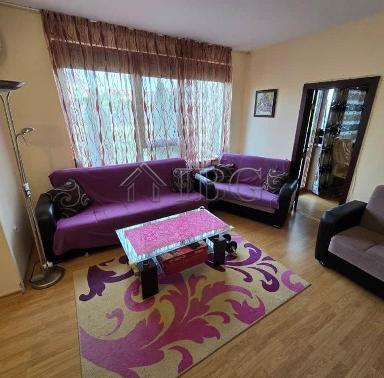 Bright living room with purple sofas and large window in Elitonia 2, Ravda.