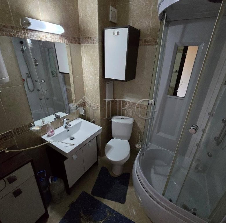 Bathroom with shower cabin, sink, and toilet in Elitonia 2, Ravda.
