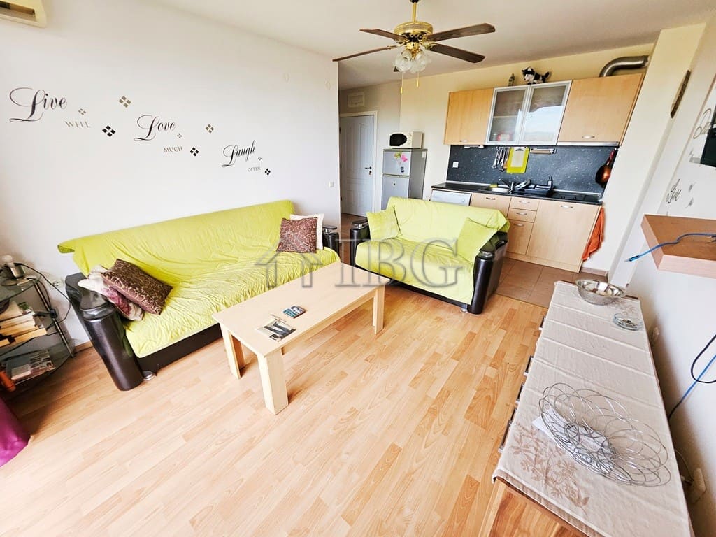 Bright living room with modern furniture and open kitchen in Sunny Beach.