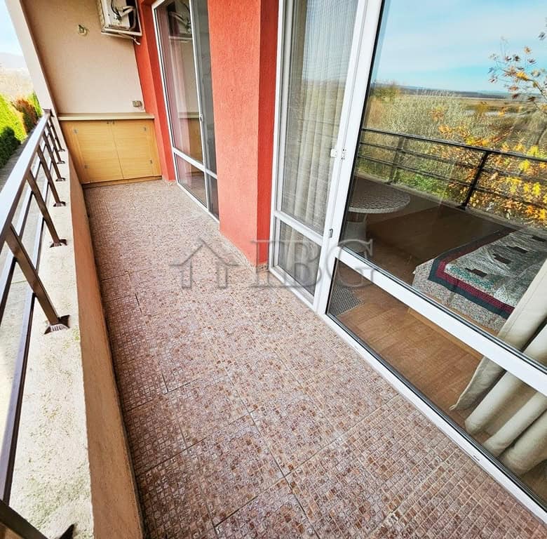 Balcony view of a sunny 2-bedroom apartment at Holiday Fort Golf Club, Sunny Beach, with outdoor sea.