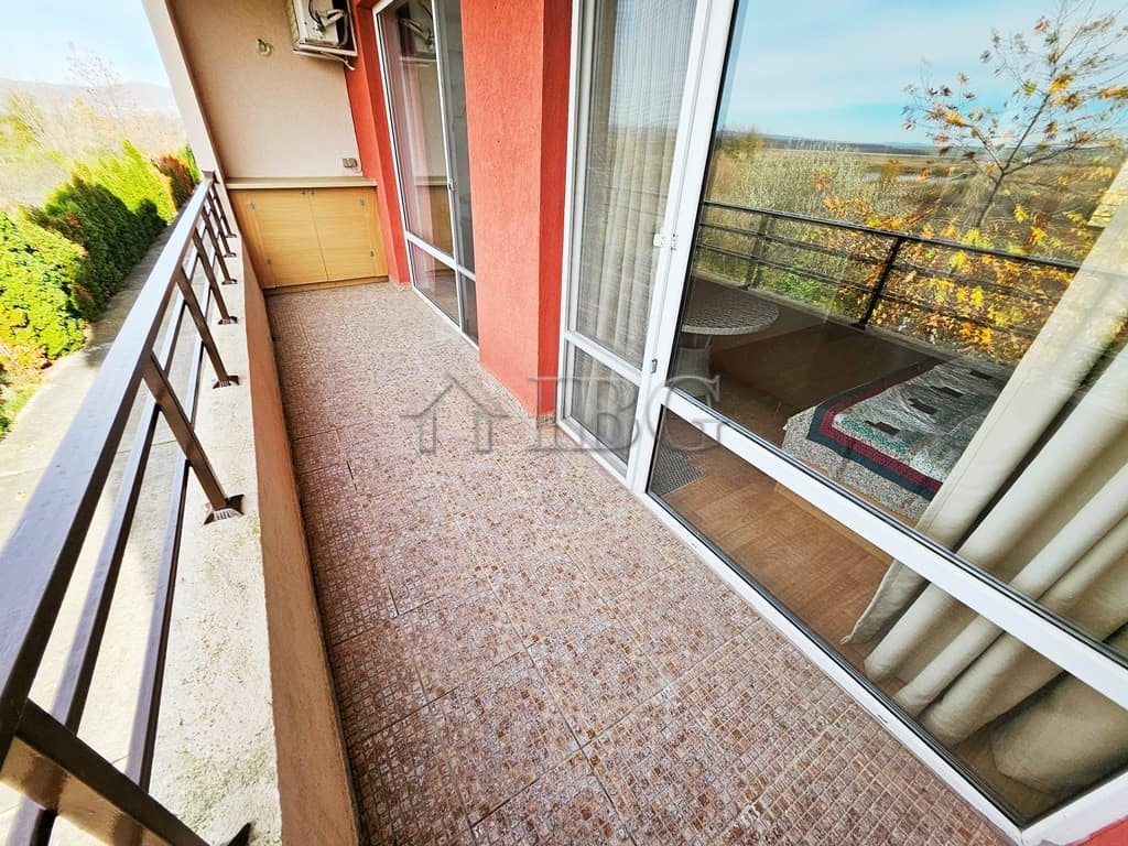Balcony view of a sunny 2-bedroom apartment at Holiday Fort Golf Club, Sunny Beach, with outdoor sea.