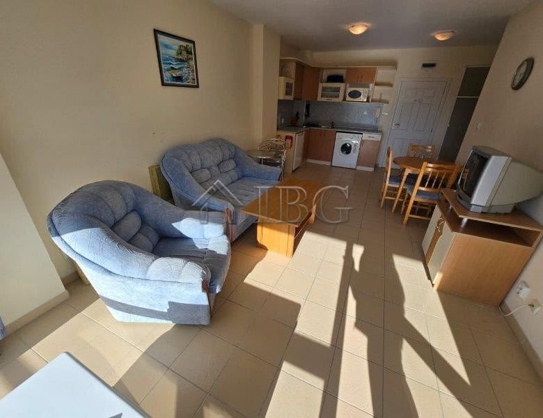 Comfortable living room with sofa, TV, and kitchen in Sea Dreams Complex, Sunny Beach.