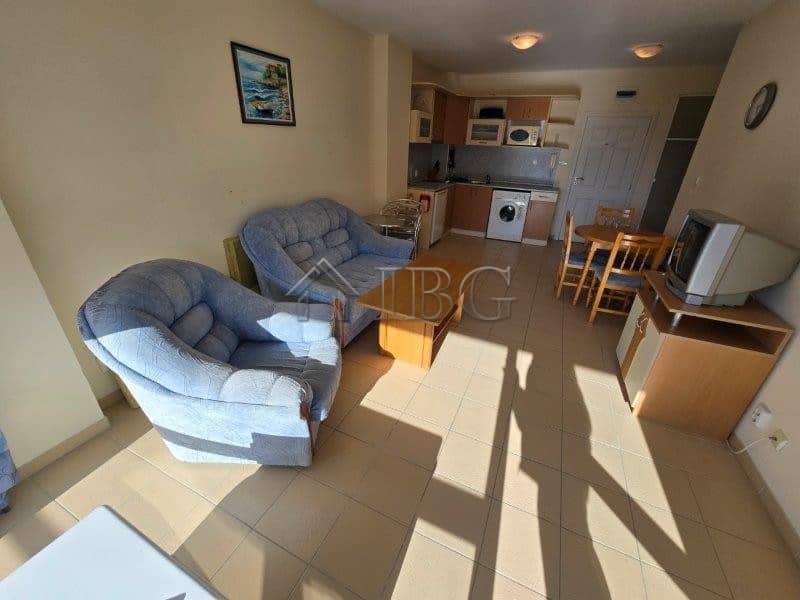 Comfortable living room with sofa, TV, and kitchen in Sea Dreams Complex, Sunny Beach.
