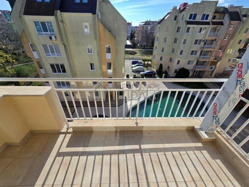 Bright balcony overlooking pool in Sunny Beach apartment complex.