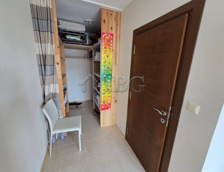 Cozy bedroom with pool view in Lifestyle 3, Ravda, Bulgaria. Modern interior with closet and seating.