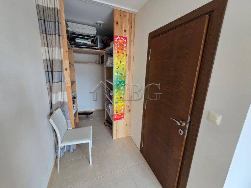Cozy bedroom with pool view in Lifestyle 3, Ravda, Bulgaria. Modern interior with closet and seating.