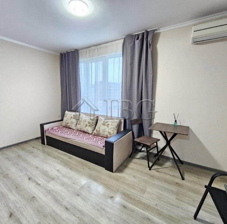 Bright studio apartment with a sofa, large window, and air conditioning in Sunny Beach. Perfect for.