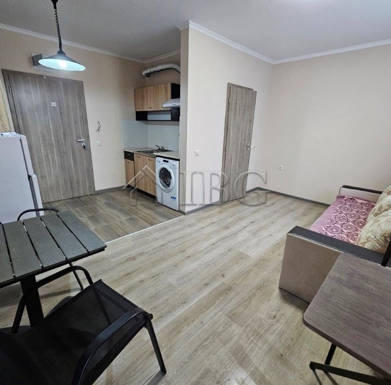 Cozy studio apartment interior with kitchenette, seating area, and dining space in Sunny Beach.