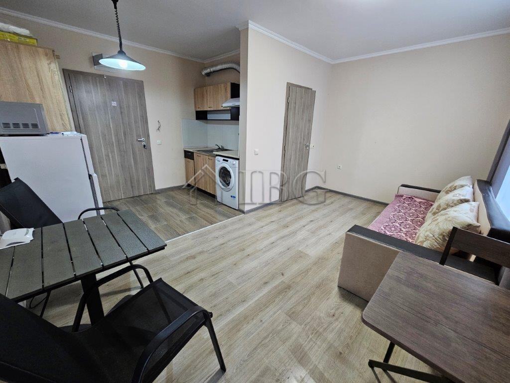 Cozy studio apartment interior with kitchenette, seating area, and dining space in Sunny Beach.