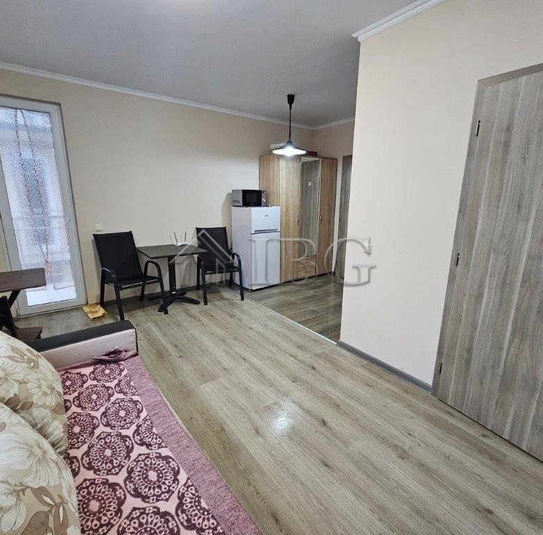 Bright studio apartment for sale in Sunny Beach, Bulgaria, featuring a living area, kitchenette, and.