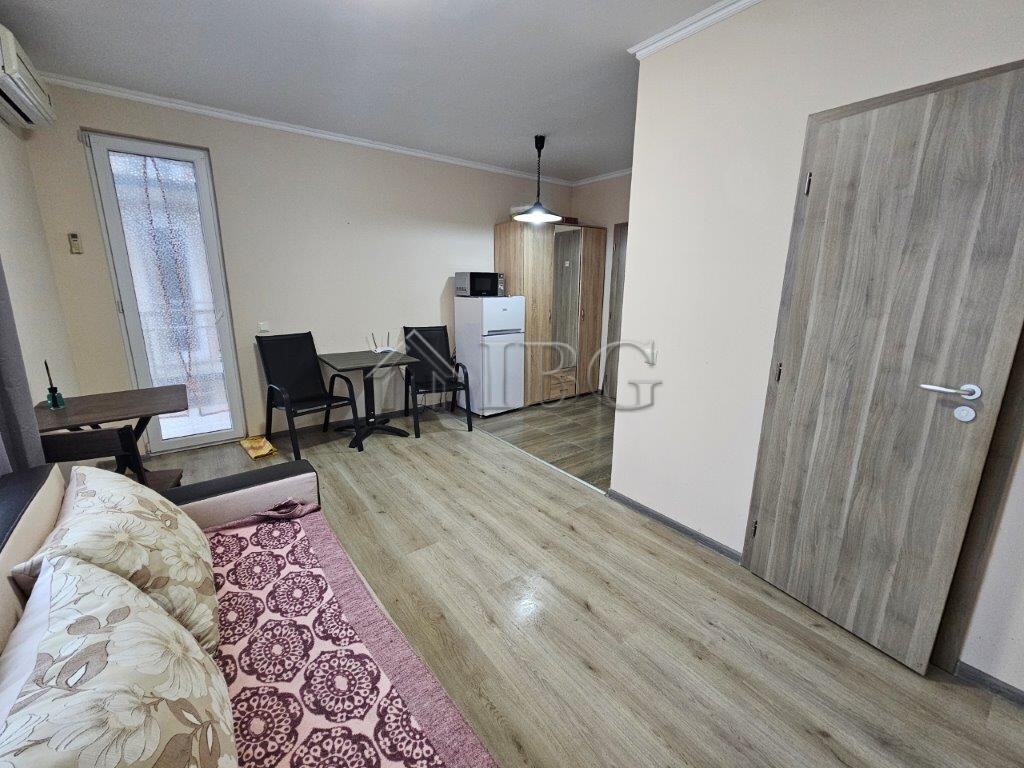 Bright studio apartment for sale in Sunny Beach, Bulgaria, featuring a living area, kitchenette, and.