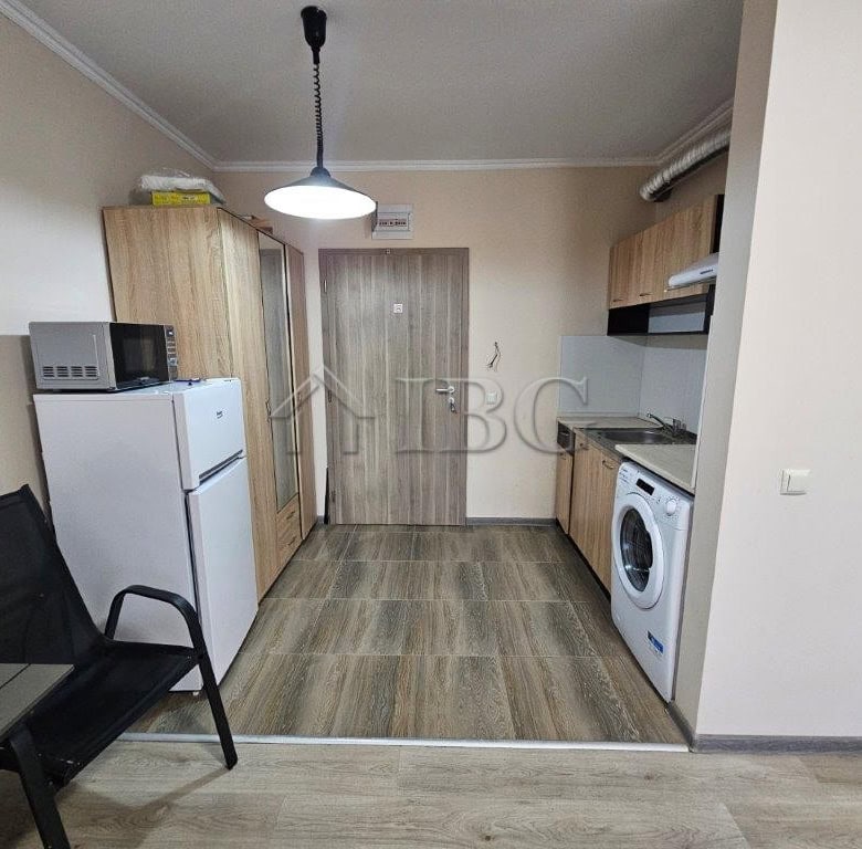 Compact studio apartment for sale in Sunny Beach, Bulgaria, featuring modern kitchen and living spac.