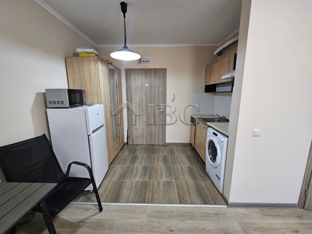 Compact studio apartment for sale in Sunny Beach, Bulgaria, featuring modern kitchen and living spac.