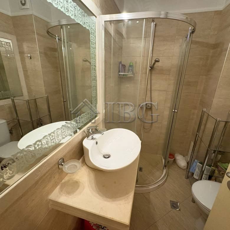 Modern bathroom with shower cabin, sink, and toilet in Harmony Palace, Sunny Beach.