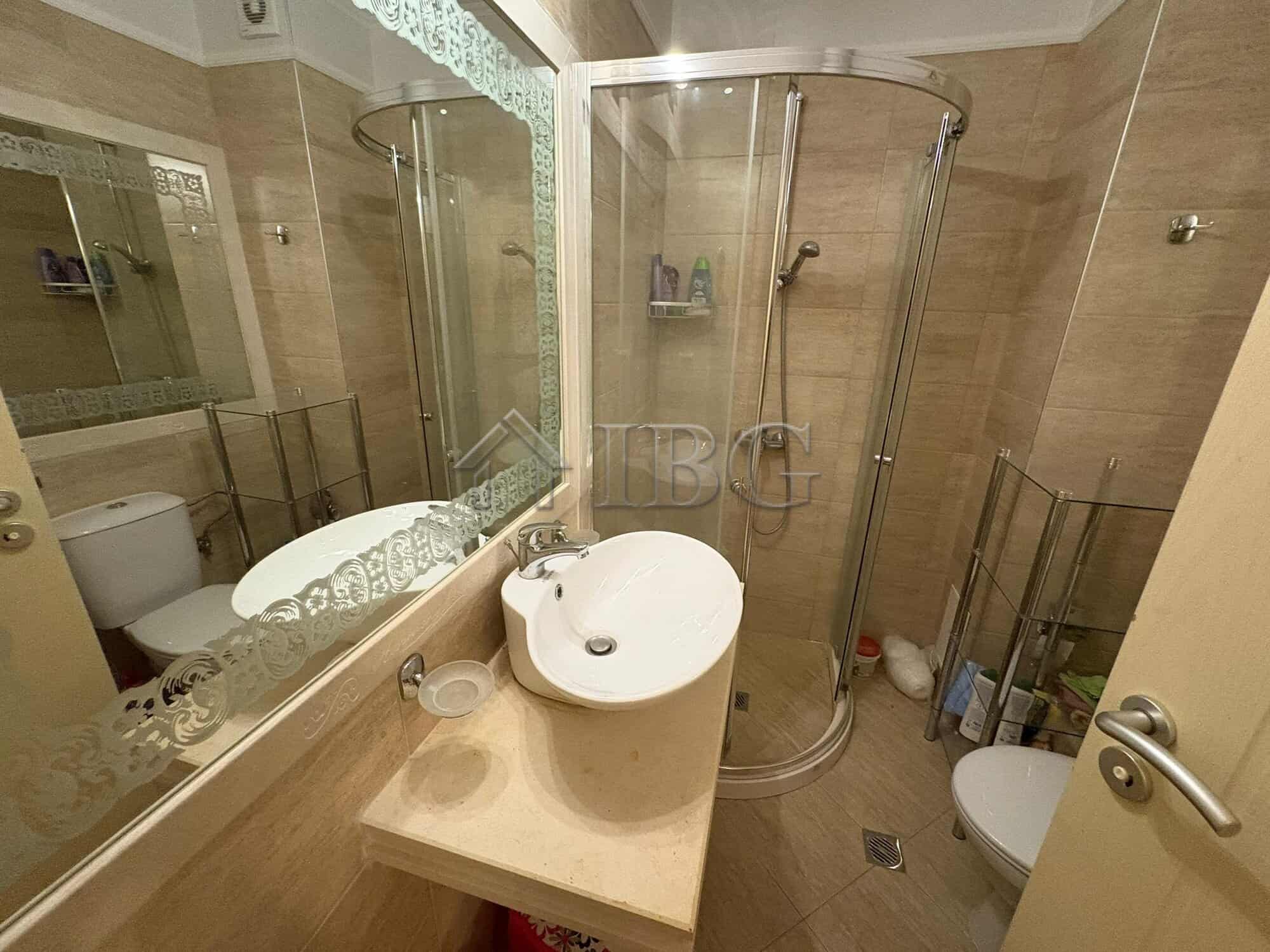 Modern bathroom with shower cabin, sink, and toilet in Harmony Palace, Sunny Beach.
