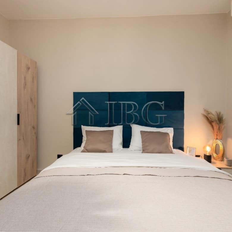 Stylish bedroom featuring a cozy bed, neutral tones, and minimalist design.