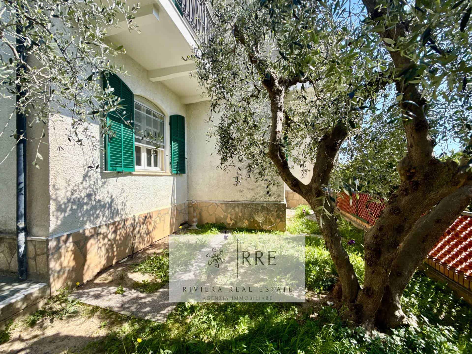 Beautiful house exterior with green shutters and garden view.
