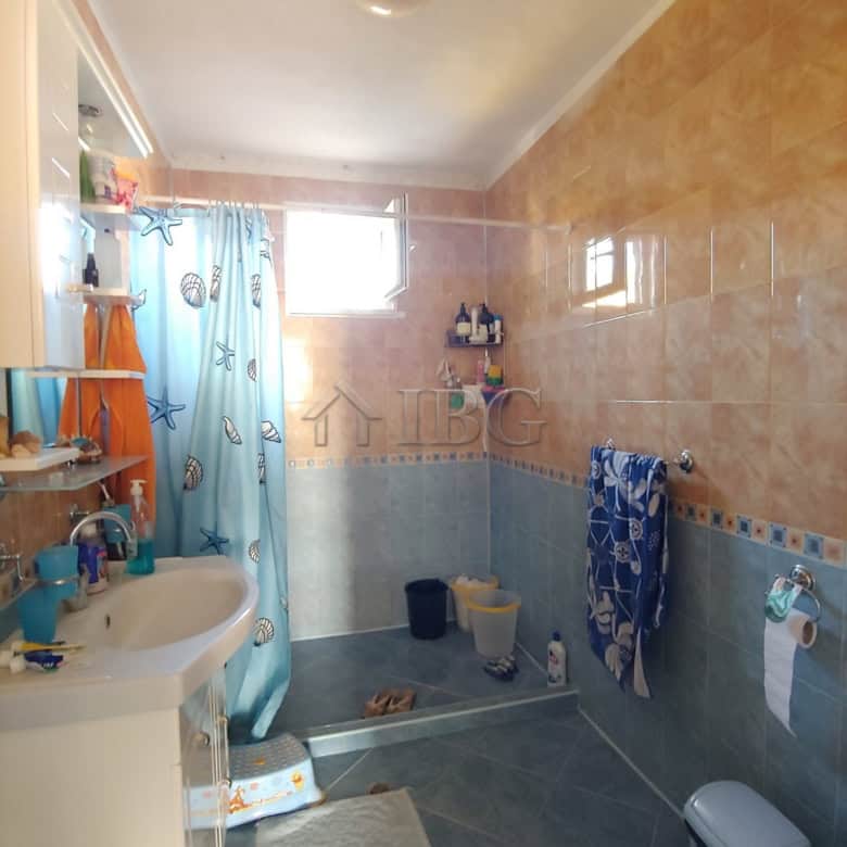 Bright bathroom with modern fixtures and colorful decor near the sea.