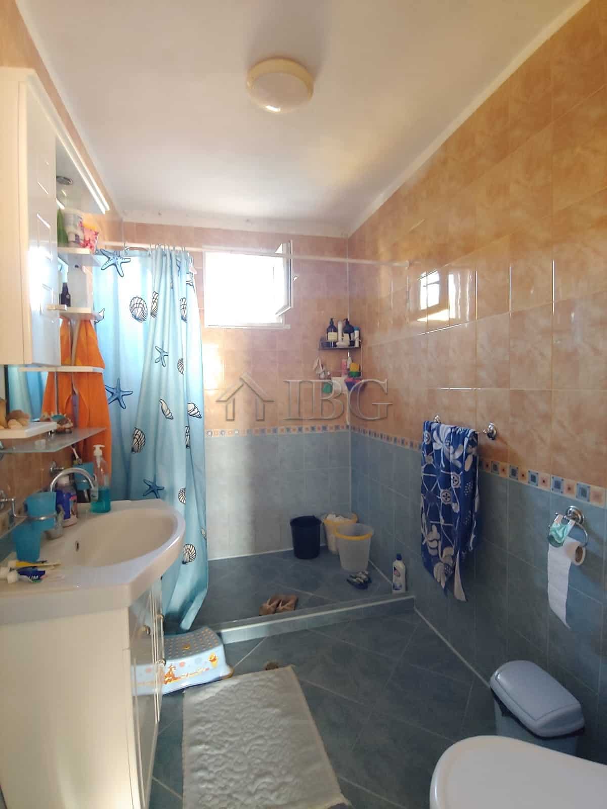 Bright bathroom with modern fixtures and colorful decor near the sea.