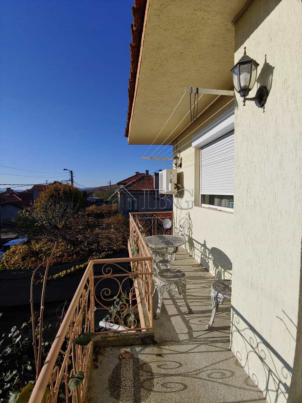 Balcony of a spacious house in Kosharitsa, Bulgaria, featuring outdoor seating and scenic views, jus.