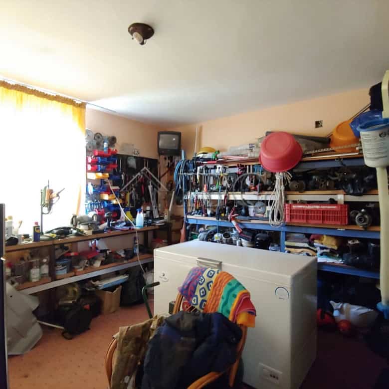 Interior view of a well-organized storage room with shelves filled with tools and household items.