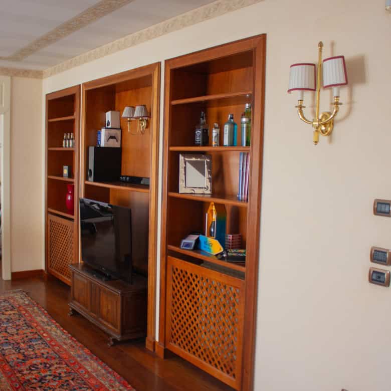 Modern living room with wooden shelving and entertainment center for home comfort.