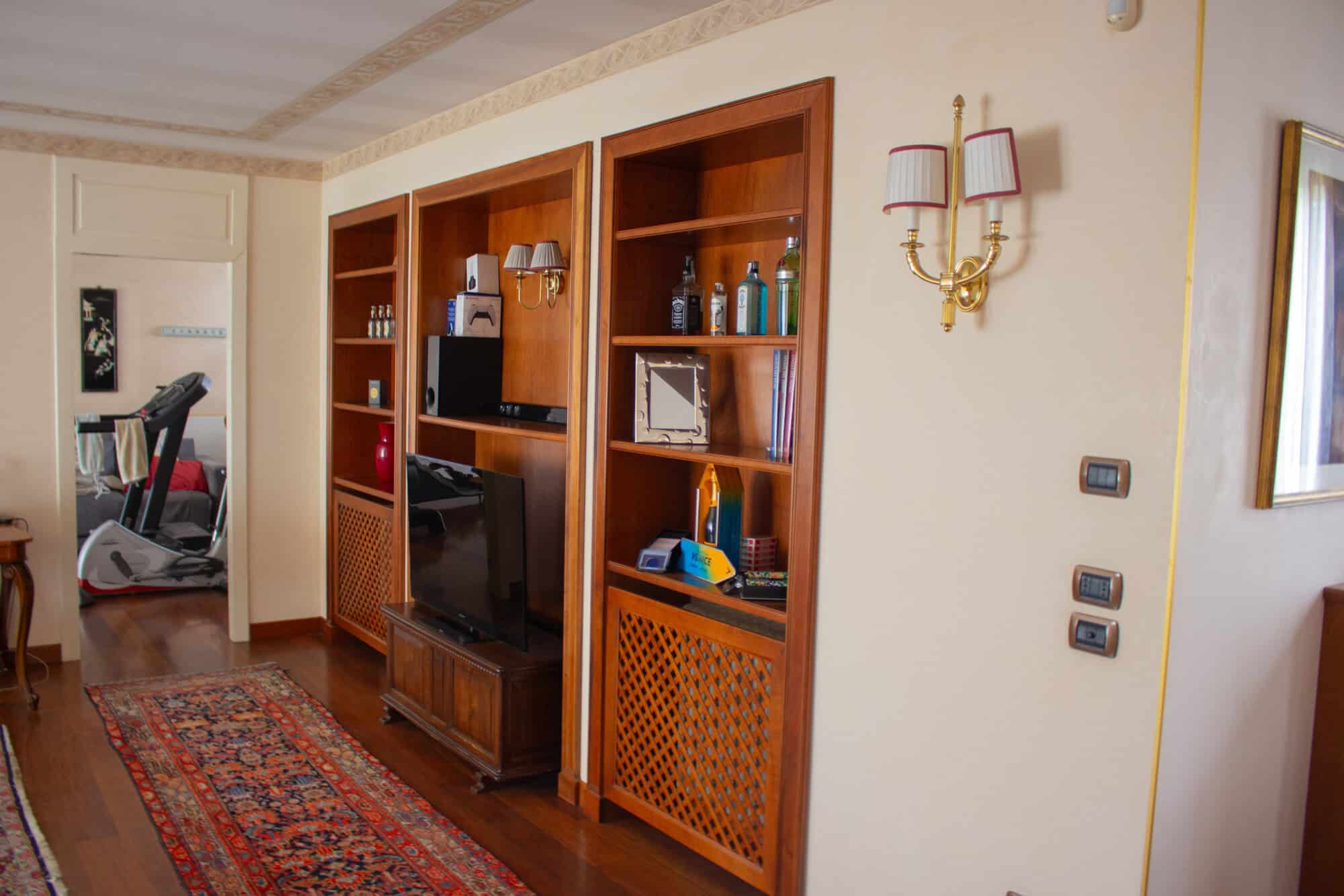 Modern living room with wooden shelving and entertainment center for home comfort.