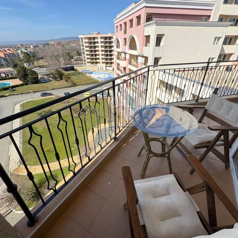 Balcony overlooking the sunny beach resort with outdoor seating and scenic ocean views. Perfect for.