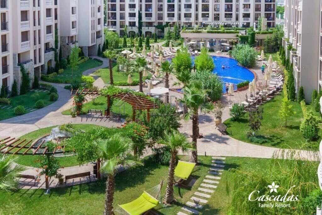 Modern garden with swimming pool and lush greenery at Cascadas Complex, Sunny Beach.