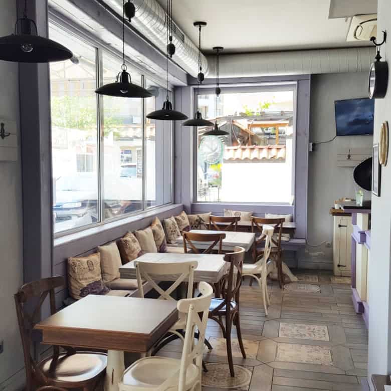 Interior view of an exclusive restaurant in Nessebar with wooden tables and comfortable seating.