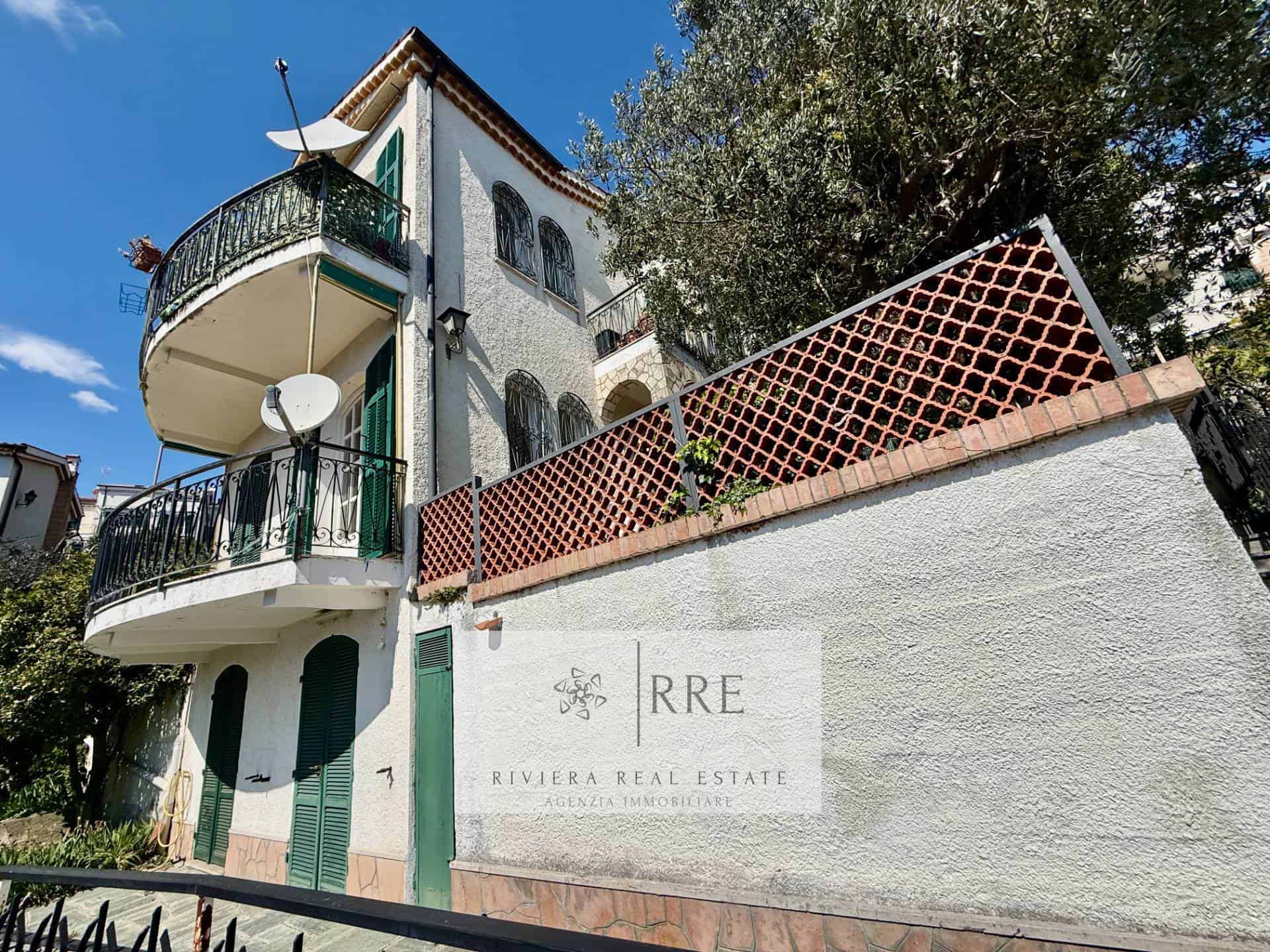 Beautiful Mediterranean villa with curved balconies and satellite dishes, set against a clear blue s.