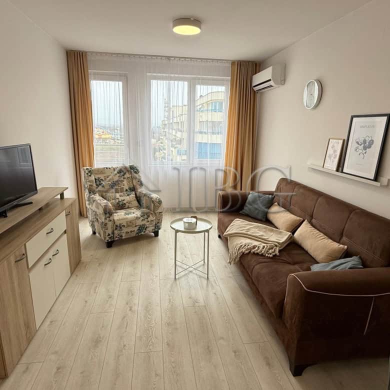 Bright living room with comfortable sofa and armchair in Pomorie Beach Resort.