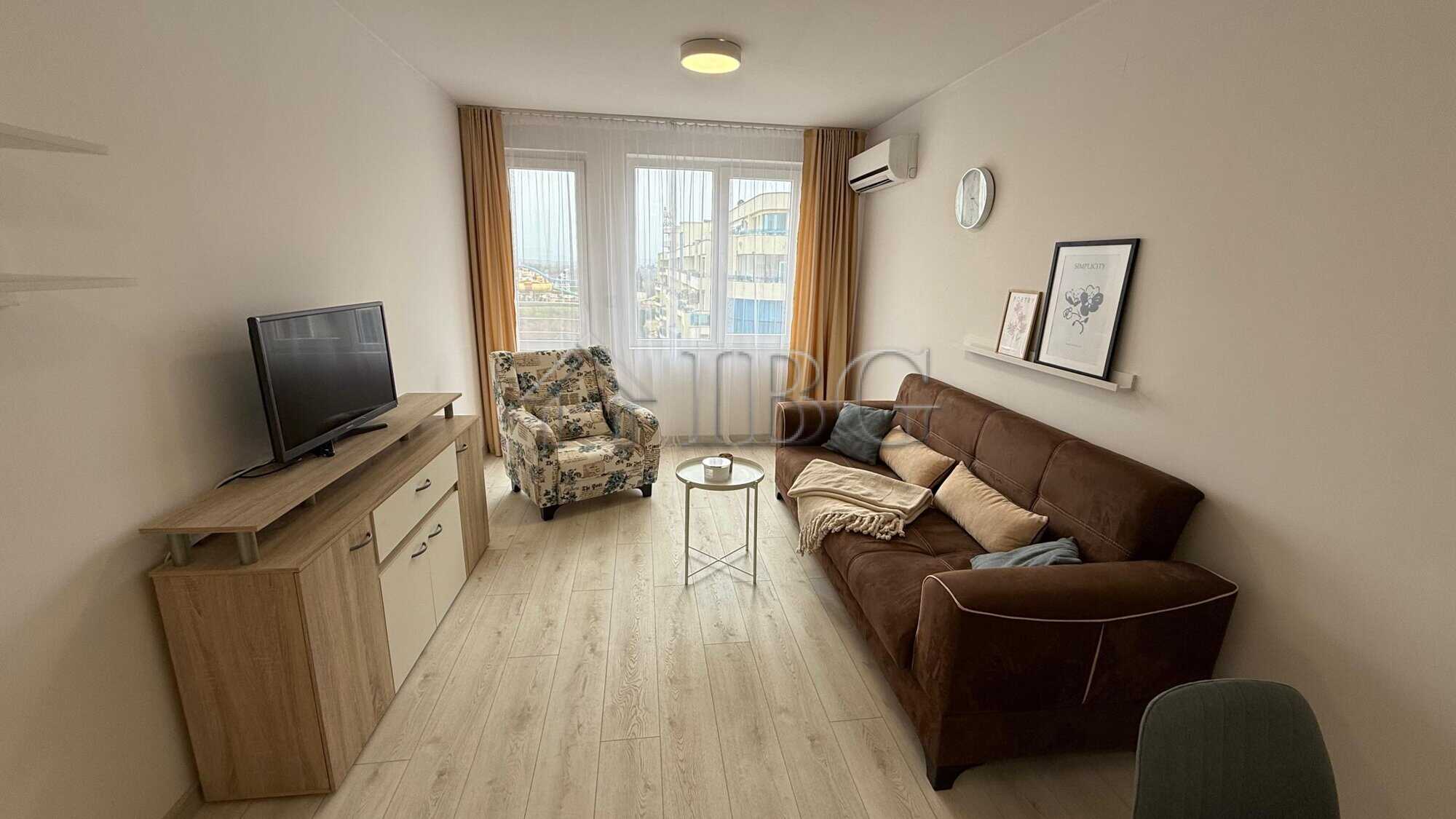 Bright living room with comfortable sofa and armchair in Pomorie Beach Resort.