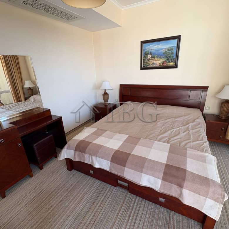 Spacious bedroom with modern furniture and balcony access at Sunny Beach. Perfect for relaxing holid.
