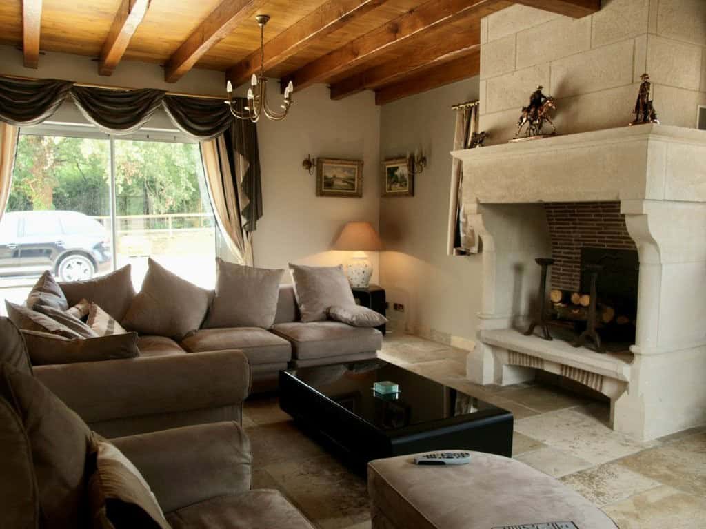 Luxury 4 Bed Le Manoir House in Dordogne Valley Elegant living room with fireplace in Dordogne Valley property.