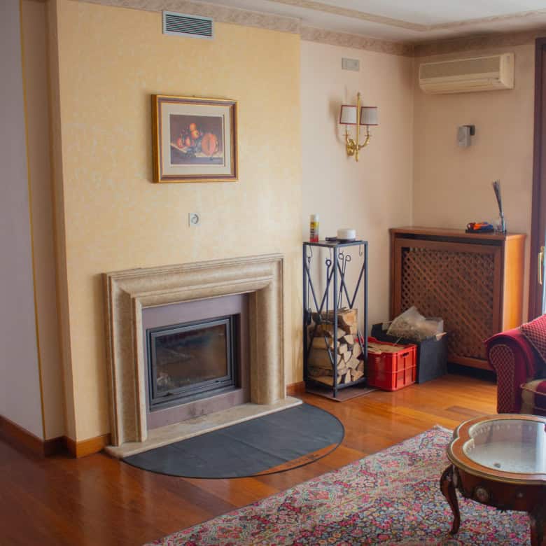 Interior of a cozy living room featuring a fireplace and classic decor.