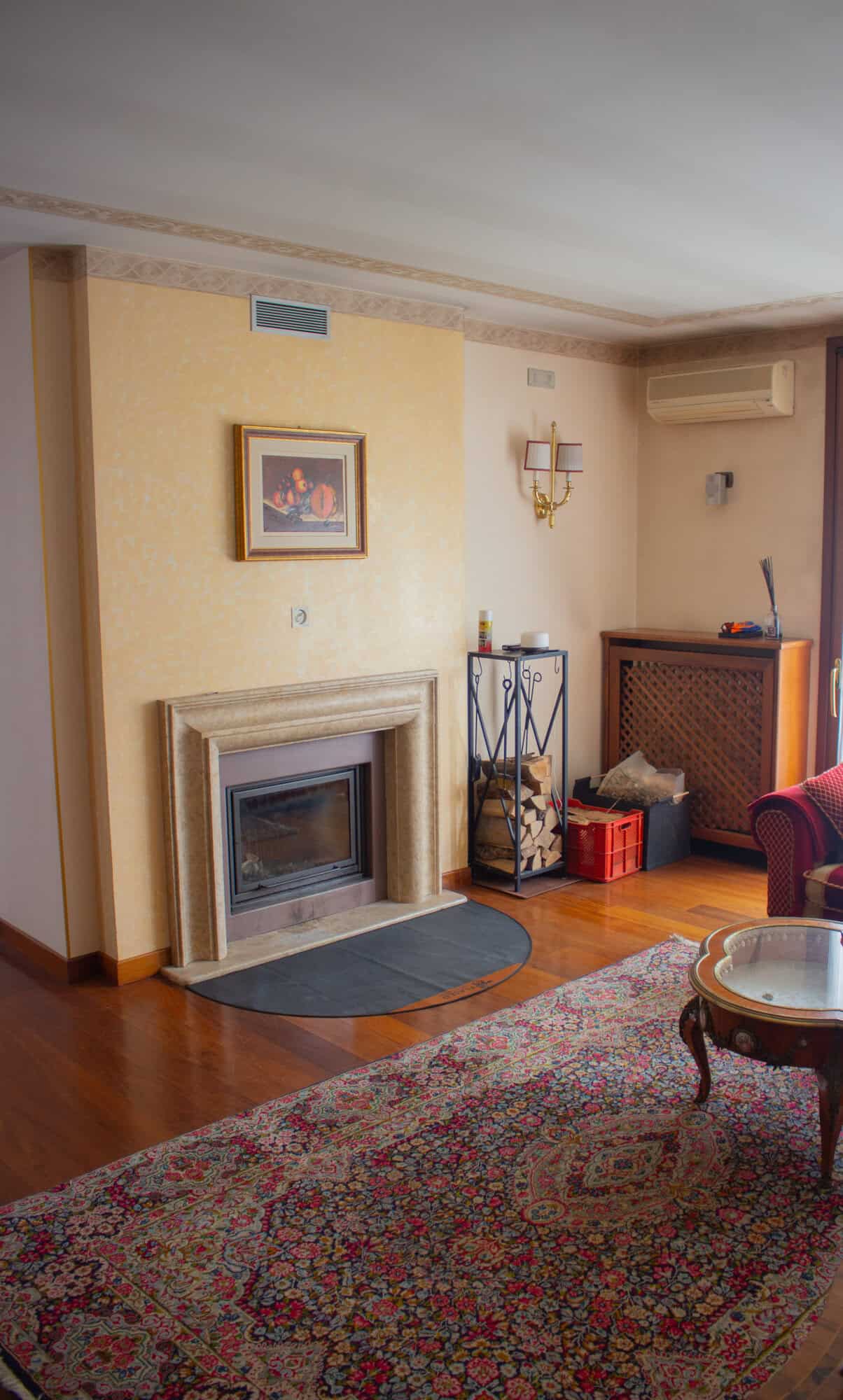 Interior of a cozy living room featuring a fireplace and classic decor.