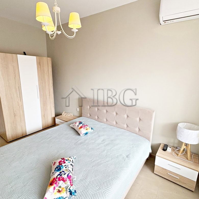 Cozy bedroom featuring a large bed, wardrobe, and modern decor with pool view. Perfect for relaxing.