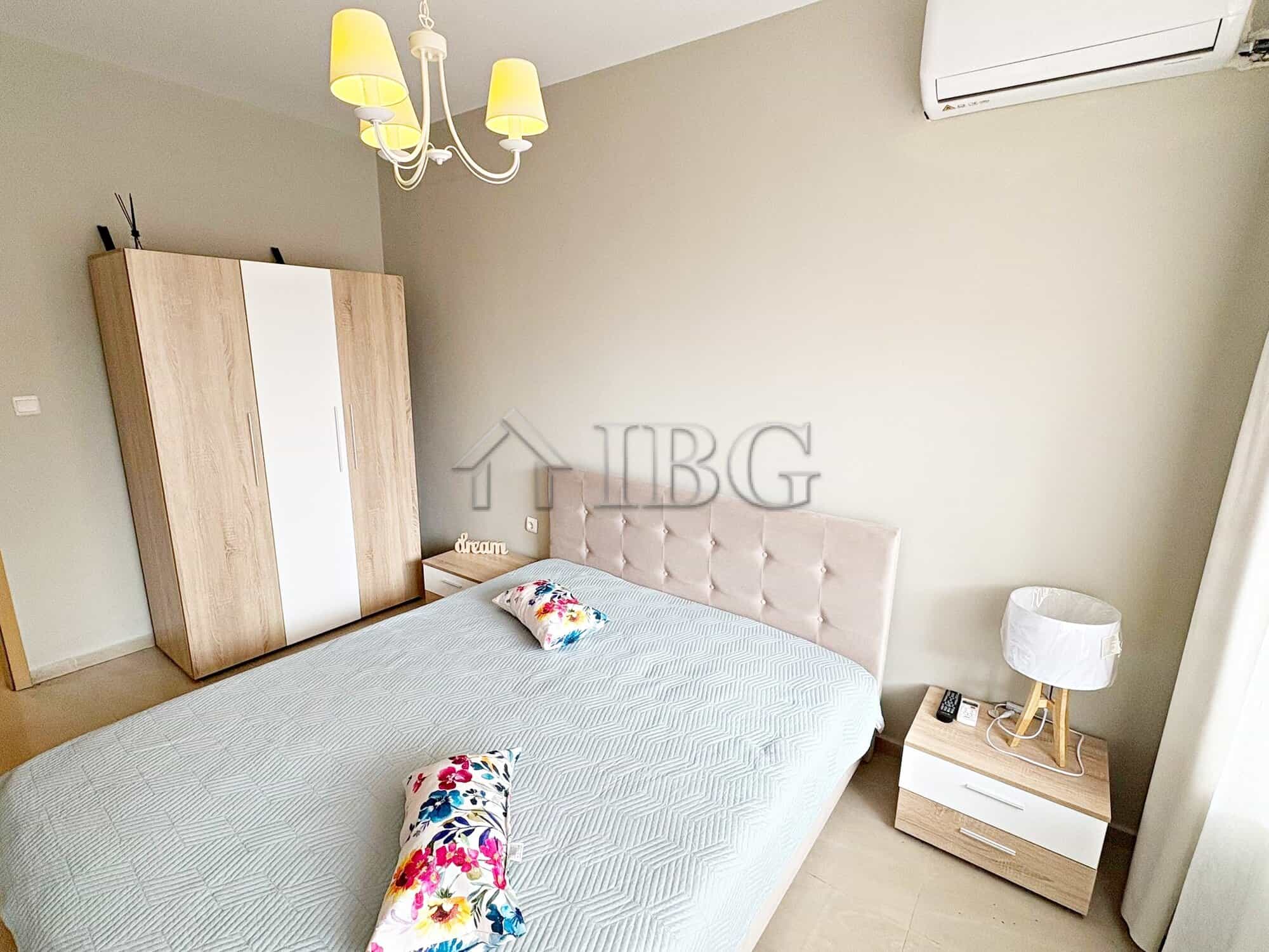 Cozy bedroom featuring a large bed, wardrobe, and modern decor with pool view. Perfect for relaxing.