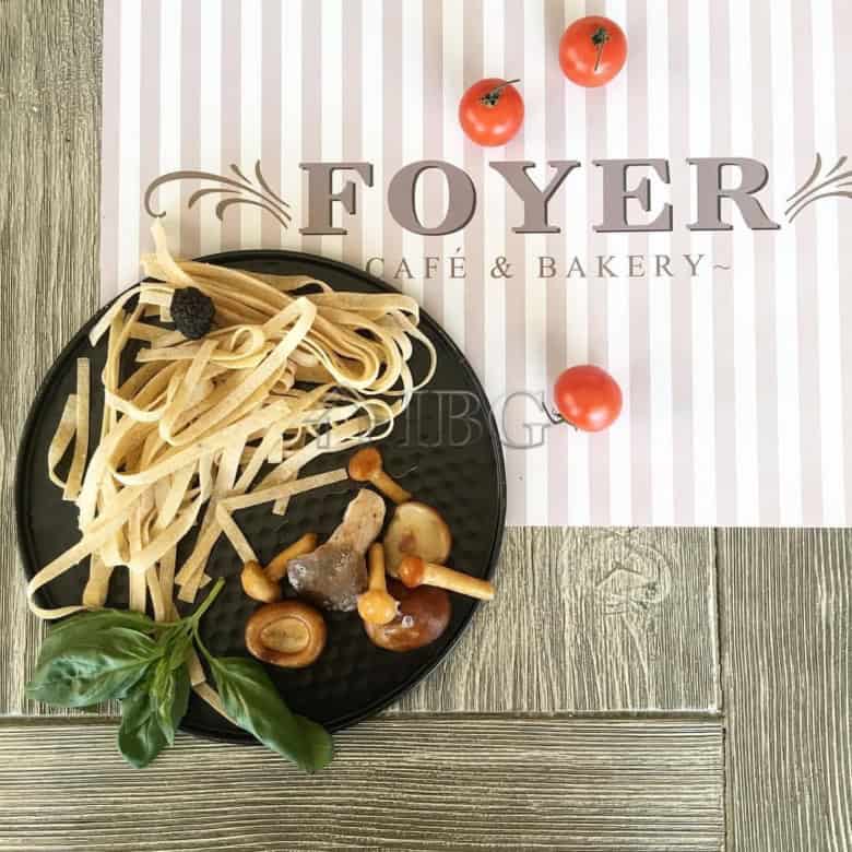 Elegant restaurant setup with pasta and fresh tomatoes in Nessebar.