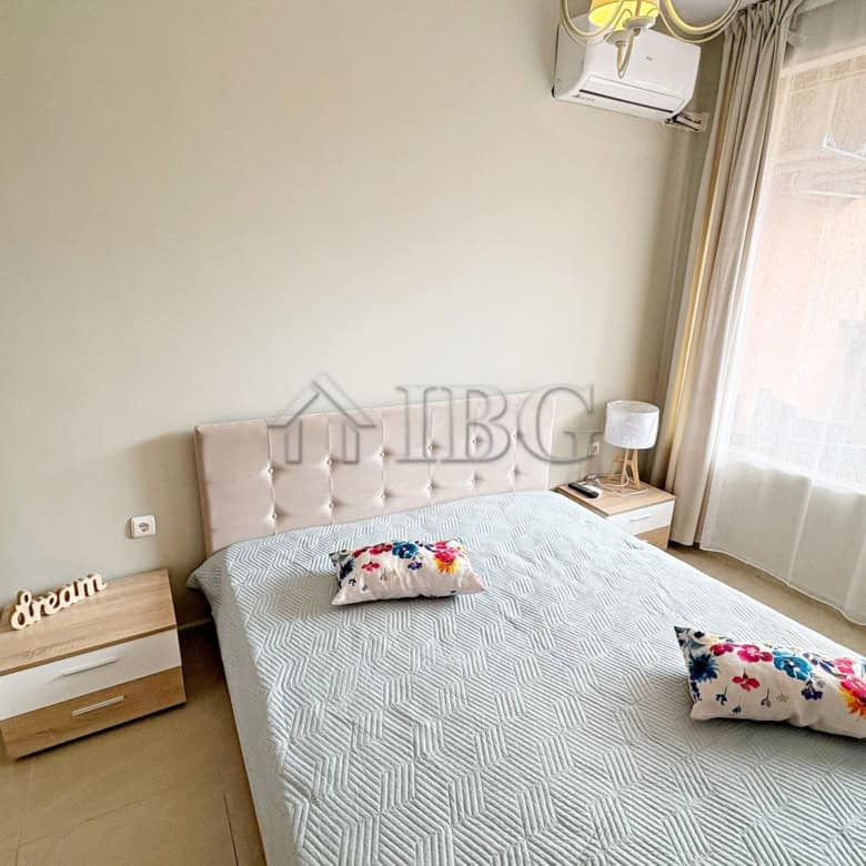 Cozy bedroom with pool view in Sunflower complex, Sunny Beach, Bulgaria. Modern furnishings and natu.