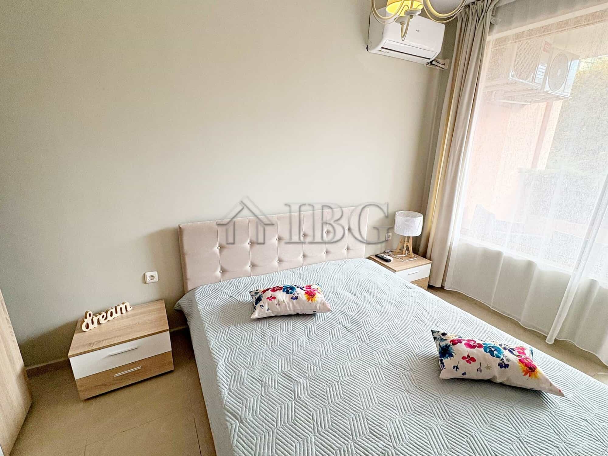 Cozy bedroom with pool view in Sunflower complex, Sunny Beach, Bulgaria. Modern furnishings and natu.