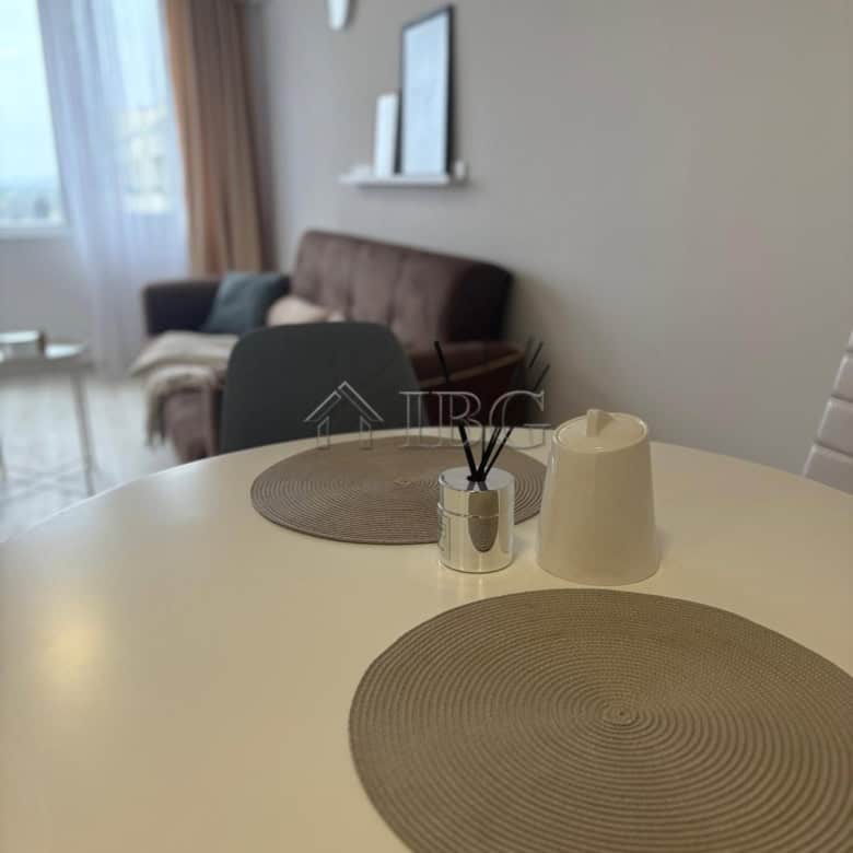 Apartment interior with dining table and living area in Pomorie Beach Resort, Bulgaria.