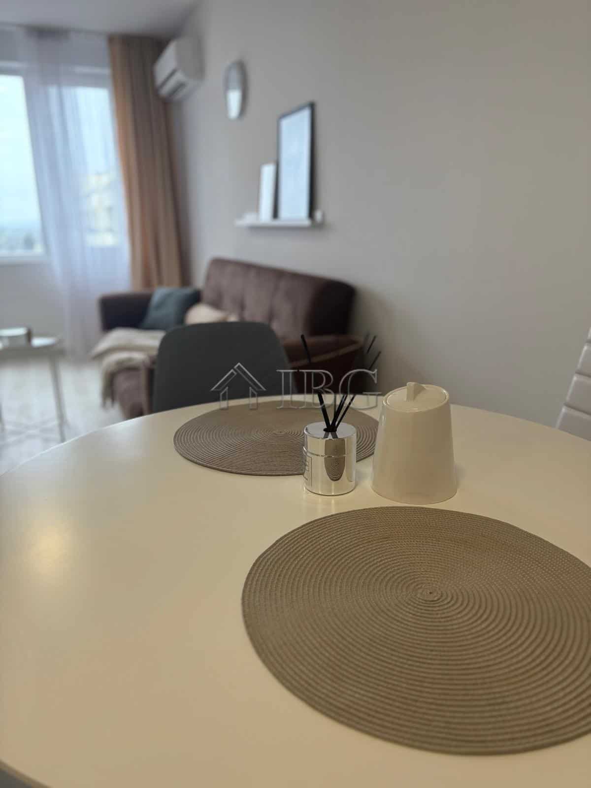 Apartment interior with dining table and living area in Pomorie Beach Resort, Bulgaria.