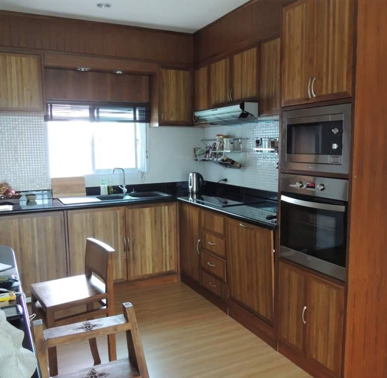 Bright kitchen with wooden cabinets and appliances.
