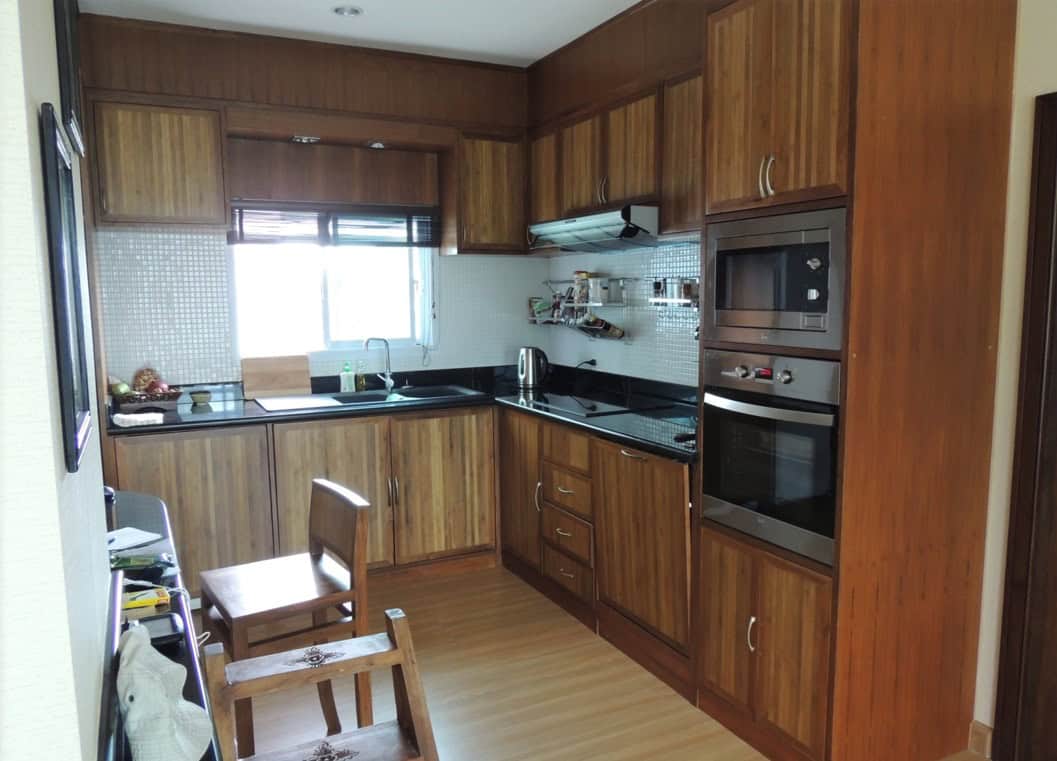 Bright kitchen with wooden cabinets and appliances.