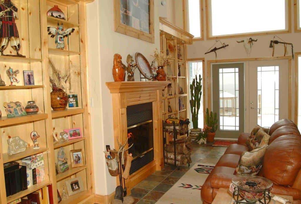 Ocean view living room with fireplace and cozy seating in Englishtown, Nova Scotia.