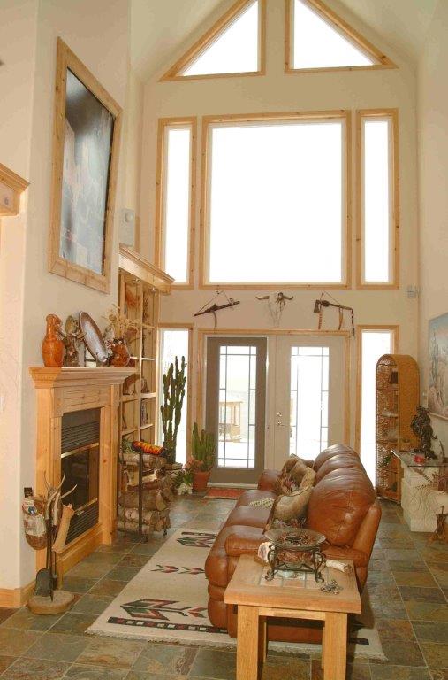 Ocean view living room with high vaulted ceilings and large windows in Englishtown, Nova Scotia.